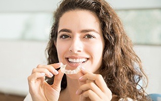 Woman placing clear aligner