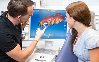 Dentist and patient looking at CEREC software