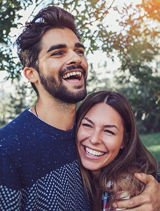 Young man and woman laughing together